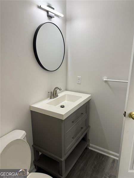 empty room featuring dark carpet and baseboards