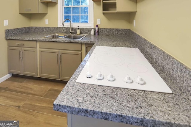 kitchen with white electric stovetop and a sink