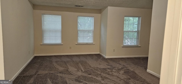 2867 Snapfinger Mnr, Decatur, GA 30035 - spare room with baseboards, dark colored carpet, visible vents, and a textured ceiling