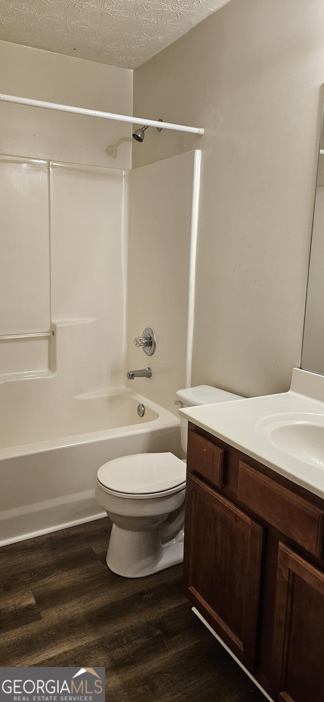 2867 Snapfinger Mnr, Decatur, GA 30035 - bathroom featuring wood finished floors, a textured ceiling, vanity, shower / tub combination, and toilet