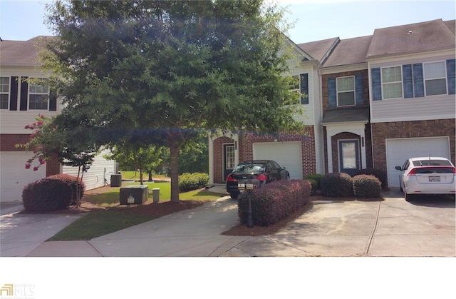 2867 Snapfinger Mnr, Decatur, GA 30035 - view of front of home featuring concrete driveway, brick siding, and a garage