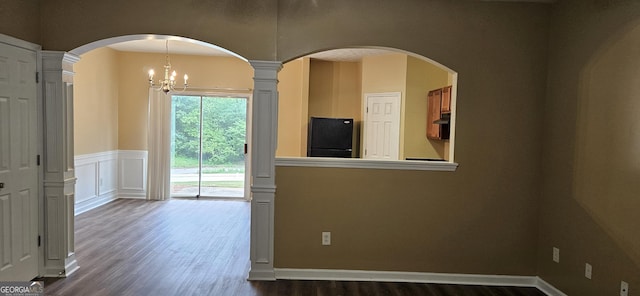 2867 Snapfinger Mnr, Decatur, GA 30035 - spare room with arched walkways, a notable chandelier, and dark wood-style flooring