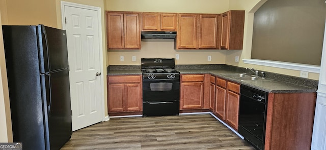 2867 Snapfinger Mnr, Decatur, GA 30035 - kitchen with dark countertops, a sink, extractor fan, black appliances, and dark wood finished floors