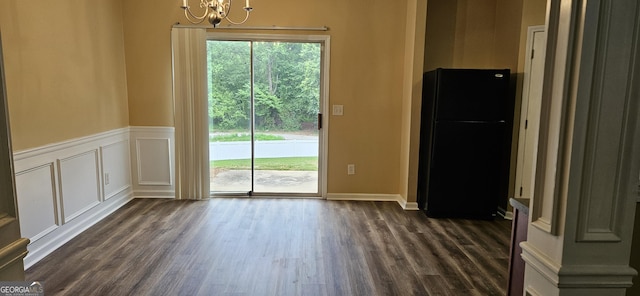 2867 Snapfinger Mnr, Decatur, GA 30035 - unfurnished dining area with a chandelier, a decorative wall, a wainscoted wall, and dark wood-style flooring