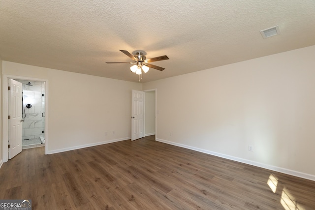 spare room featuring wood finished floors, baseboards, a ceiling fan, and visible vents