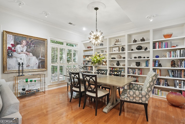 104 Glentown Way, Sandy Springs, GA 30328 - dining area featuring visible vents, built in shelves, wood finished floors, a chandelier, and ornamental molding