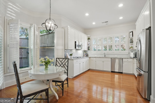 104 Glentown Way, Sandy Springs, GA 30328 - kitchen featuring visible vents, ornamental molding, light stone countertops, a sink, and stainless steel appliances