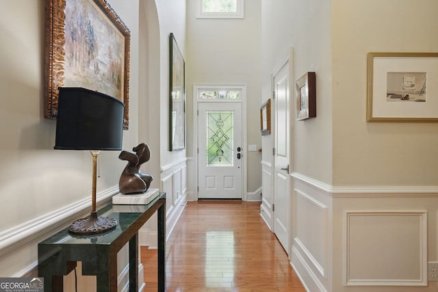 104 Glentown Way, Sandy Springs, GA 30328 - doorway to outside with a high ceiling, a decorative wall, hardwood / wood-style flooring, and a wainscoted wall