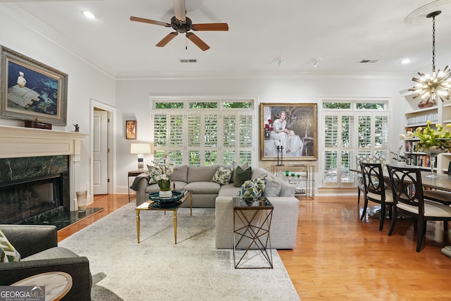 104 Glentown Way, Sandy Springs, GA 30328 - living room featuring visible vents, crown molding, ceiling fan with notable chandelier, and a fireplace