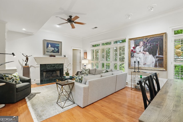 104 Glentown Way, Sandy Springs, GA 30328 - living room with crown molding, ceiling fan, wood finished floors, a high end fireplace, and visible vents
