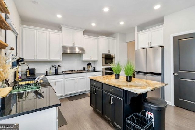 371 Northaven Ave, Suwanee, GA 30024 - kitchen with under cabinet range hood, stainless steel appliances, white cabinets, and recessed lighting