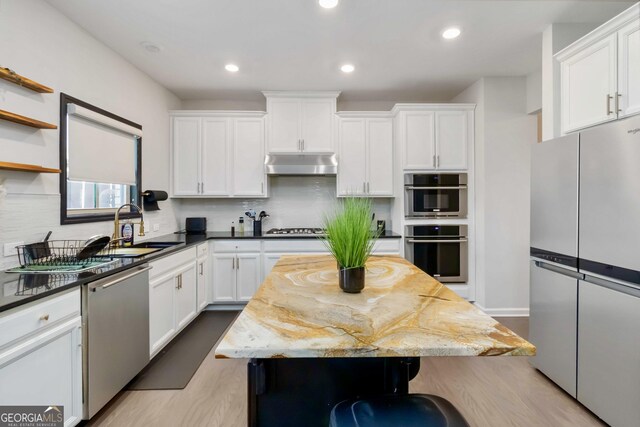 371 Northaven Ave, Suwanee, GA 30024 - kitchen with appliances with stainless steel finishes, under cabinet range hood, wood finished floors, white cabinetry, and recessed lighting