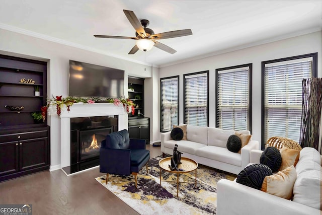371 Northaven Ave, Suwanee, GA 30024 - living room with a ceiling fan, ornamental molding, wood finished floors, and a warm lit fireplace