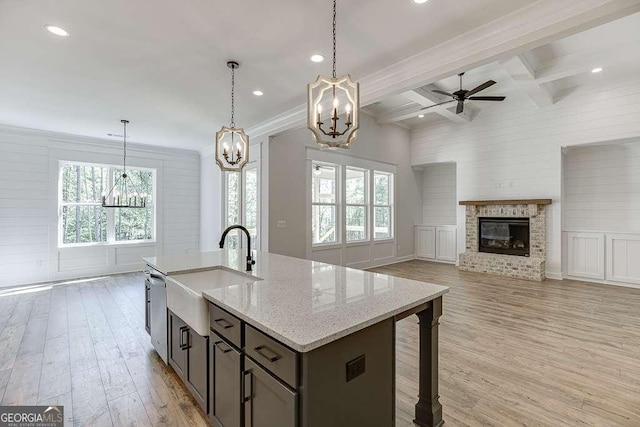 kitchen with a sink, a chandelier, ceiling fan, plenty of natural light, and beamed ceiling