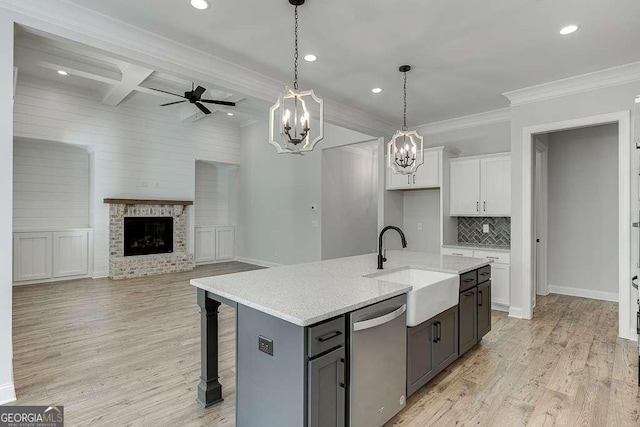 kitchen with dishwasher, a sink, white cabinets, recessed lighting, and decorative backsplash