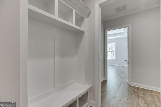 mudroom featuring light wood-style floors and baseboards