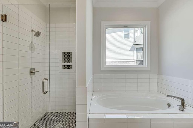 full bath with a shower stall, a bath, and ornamental molding