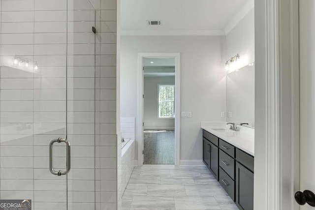 bathroom with crown molding, a shower stall, vanity, a bath, and baseboards