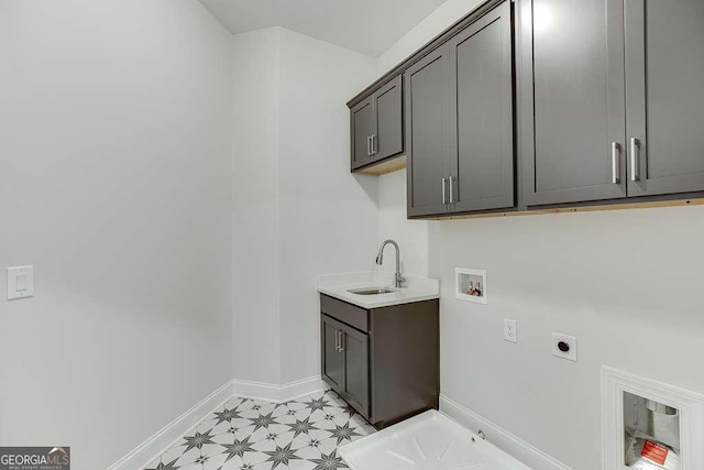 laundry room with electric dryer hookup, cabinet space, hookup for a washing machine, baseboards, and gas dryer hookup