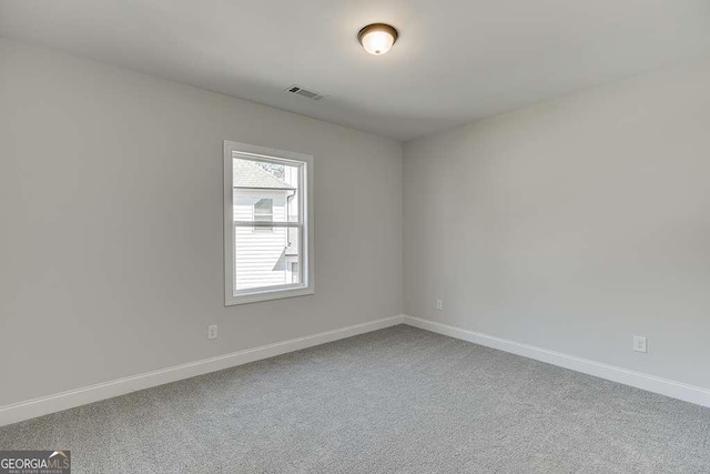 carpeted empty room with baseboards
