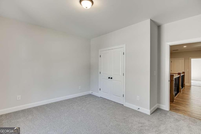 carpeted spare room with baseboards