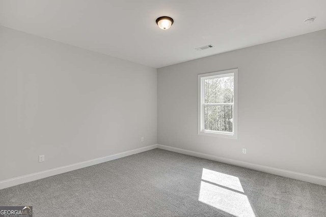 carpeted spare room with baseboards