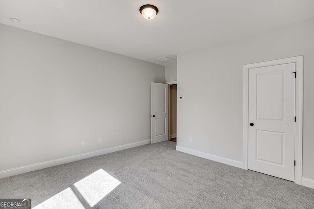 spare room with carpet flooring and baseboards