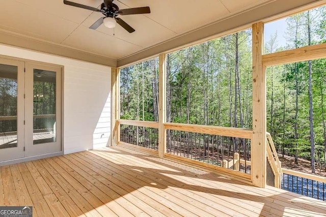 wooden deck with french doors and a ceiling fan