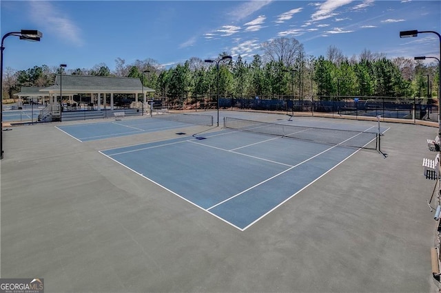 view of tennis court with fence