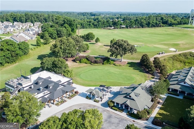 aerial perspective of suburban area with a golf course and a forest