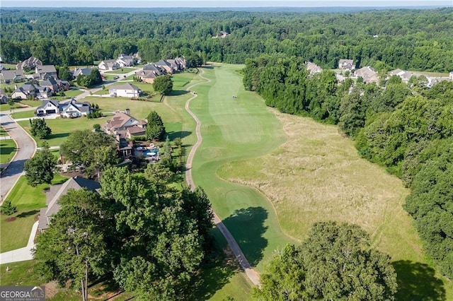 aerial overview of property's location with a forest, nearby suburban area, and a local golf course