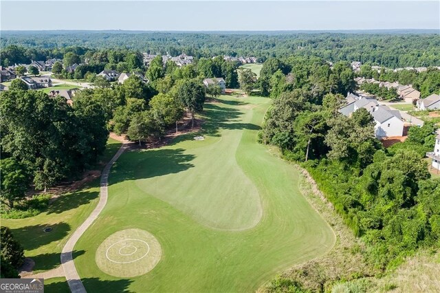 aerial perspective of suburban area with a golf club and a forest