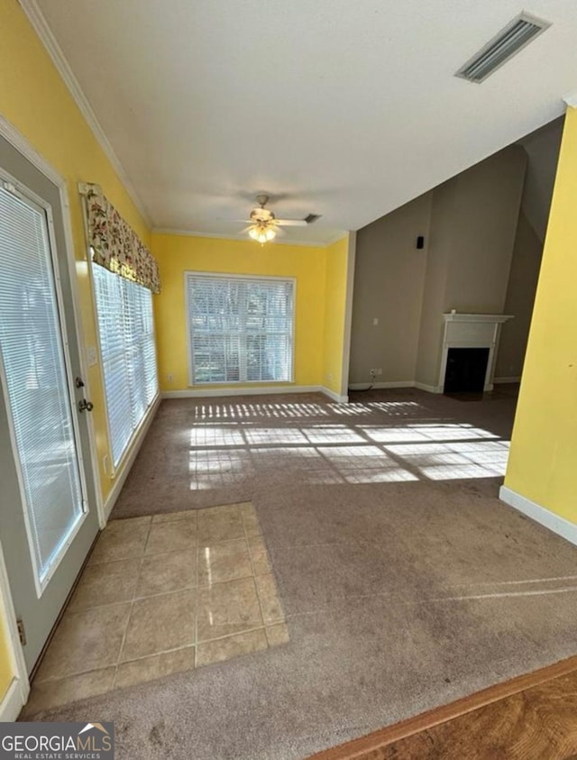 unfurnished living room with ceiling fan, baseboards, visible vents, and carpet