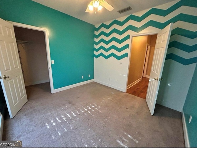 unfurnished bedroom with baseboards, visible vents, and carpet