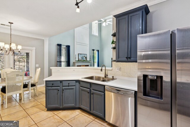 2267 Howell Farms Trl, Acworth, GA 30101 - kitchen featuring stainless steel appliances, a peninsula, a sink, light countertops, and light tile patterned floors
