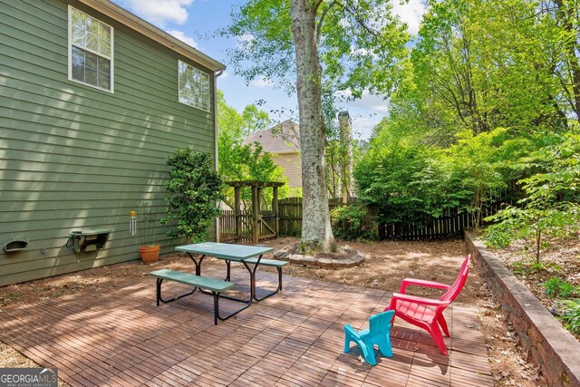 2267 Howell Farms Trl, Acworth, GA 30101 - view of patio featuring a fenced backyard, a wooden deck, and outdoor dining space