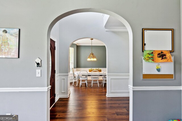 2267 Howell Farms Trl, Acworth, GA 30101 - corridor with a wainscoted wall, wood finished floors, arched walkways, a decorative wall, and crown molding