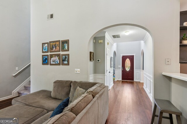 2267 Howell Farms Trl, Acworth, GA 30101 - living area featuring arched walkways, dark wood finished floors, visible vents, and crown molding
