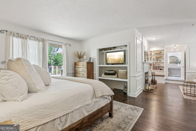 400 Peachtree Pkwy, Peachtree City, GA 30269 - bedroom featuring a textured ceiling, dark wood-style flooring, and access to exterior