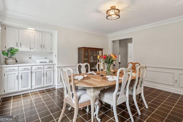 400 Peachtree Pkwy, Peachtree City, GA 30269 - dining area featuring crown molding, dark tile patterned floors, wainscoting, and a decorative wall