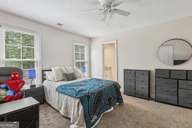 400 Peachtree Pkwy, Peachtree City, GA 30269 - carpeted bedroom featuring a textured ceiling, ceiling fan, and connected bathroom