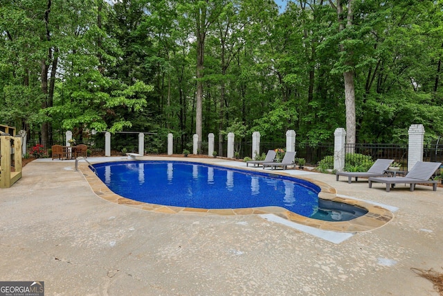 400 Peachtree Pkwy, Peachtree City, GA 30269 - view of swimming pool featuring a patio area, fence, and view of wooded area