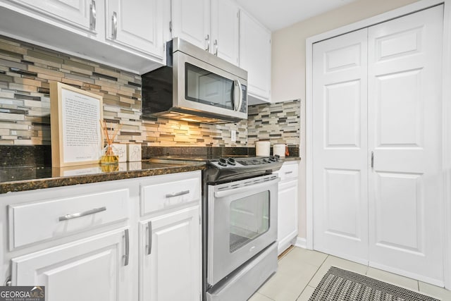 3481 Lakeside Dr NE Unit 601, Atlanta, GA 30326 - kitchen featuring stainless steel appliances, backsplash, white cabinetry, and light tile patterned floors