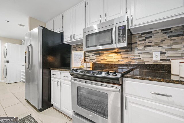 3481 Lakeside Dr NE Unit 601, Atlanta, GA 30326 - kitchen featuring white cabinetry, tasteful backsplash, stainless steel appliances, and light tile patterned floors