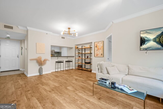 3481 Lakeside Dr NE Unit 601, Atlanta, GA 30326 - living room featuring light wood-style flooring, visible vents, a chandelier, and ornamental molding