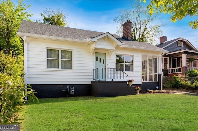 view of front of property with a chimney and a front yard