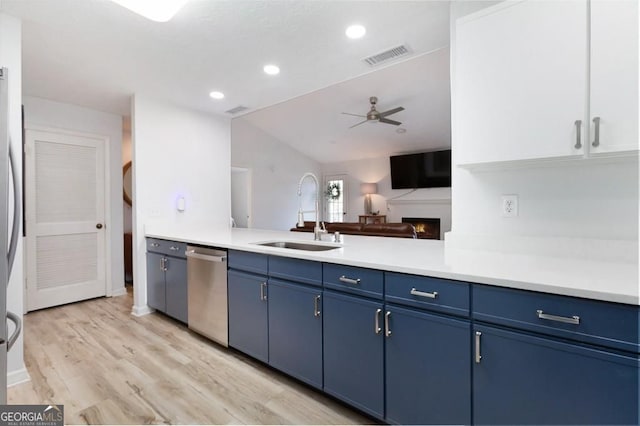 384 Teal Ct, Roswell, GA 30076 - kitchen featuring stainless steel dishwasher, a sink, blue cabinets, ceiling fan, and light countertops