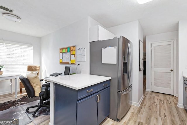 384 Teal Ct, Roswell, GA 30076 - kitchen with blue cabinets, visible vents, light wood-style floors, stainless steel refrigerator with ice dispenser, and light countertops