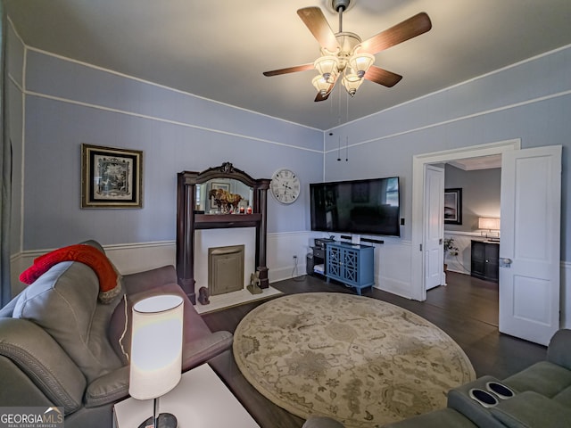 living area featuring a ceiling fan and wood finished floors