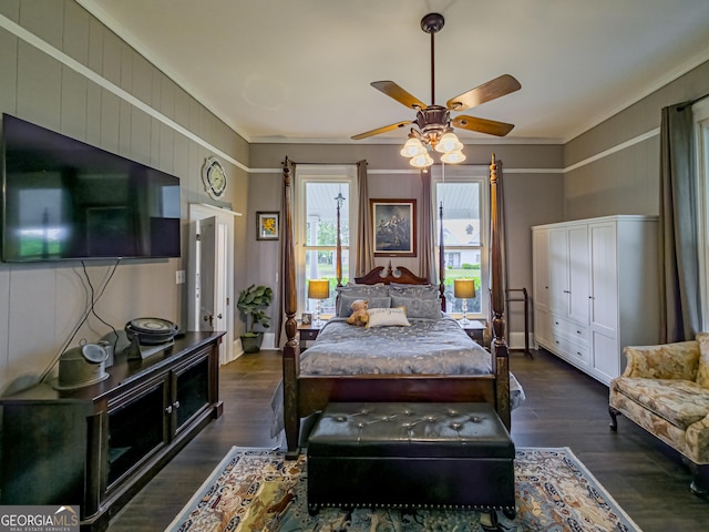 bedroom with wood finished floors, crown molding, and a ceiling fan